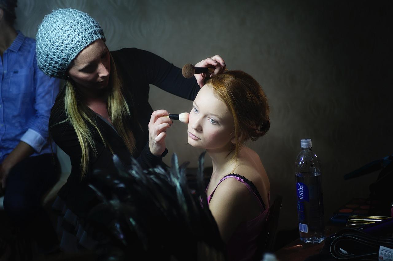 Stylist applies face powder