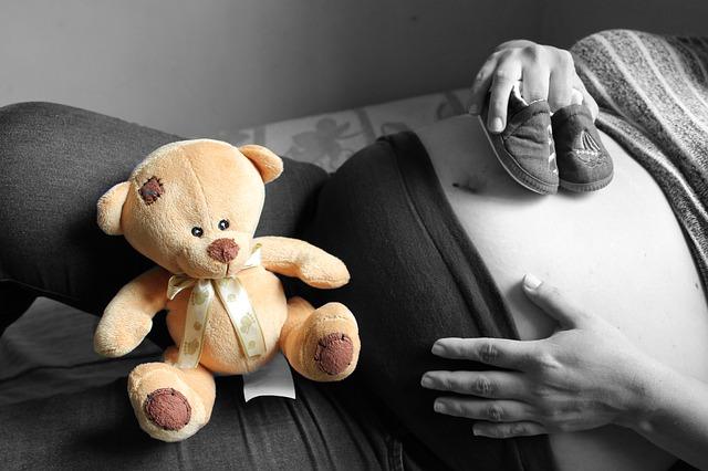 Fille enceinte avec un ours en peluche