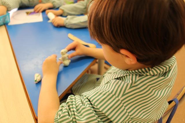 A boy plays with a slit of sodium tetraborate and glue