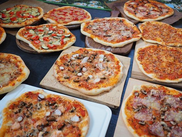 Different types of pizza on the table