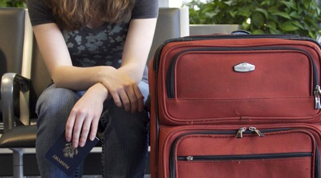 At the airport with a suitcase